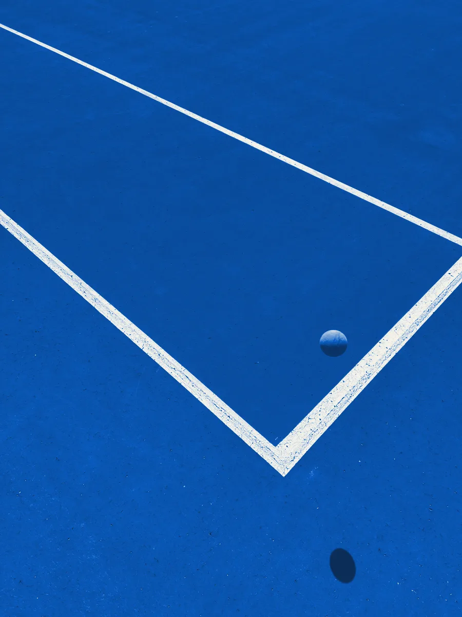 Aerial view of a court corner with a single tennis ball