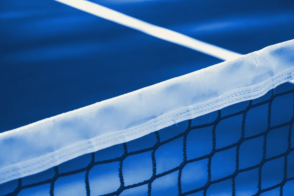 Close-up of a tennis net's white tape
